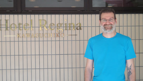 Earl next to the hotel sign